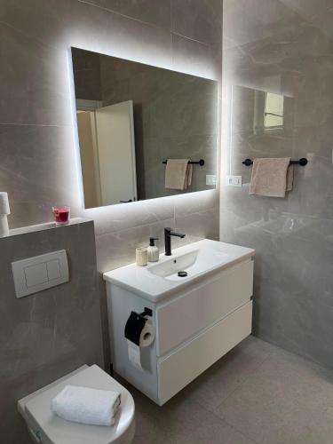 a bathroom with a white sink and a mirror at The White House Split in Split