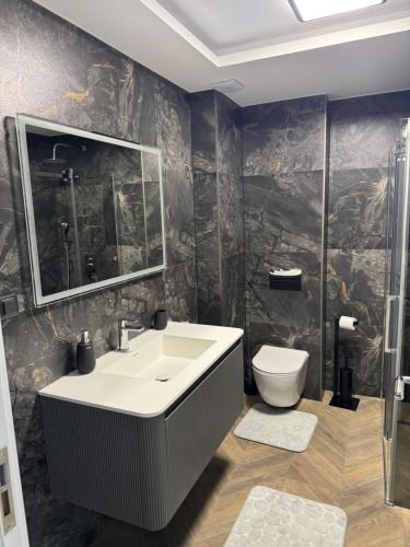 a bathroom with a sink and a toilet at AD Home in Bar