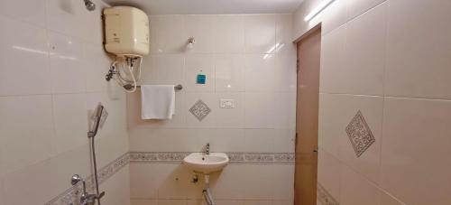 a white bathroom with a sink and a shower at Sun Private Pool Villa in Puducherry Airpoert