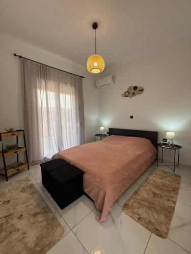 a bedroom with a large bed and a large window at Casa Kallisti in Livadeia