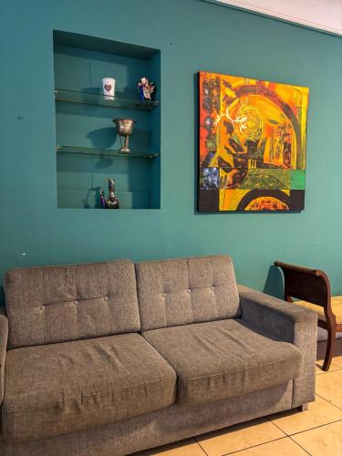 a living room with a couch and a painting on the wall at Hostel rivendell lima in Lima