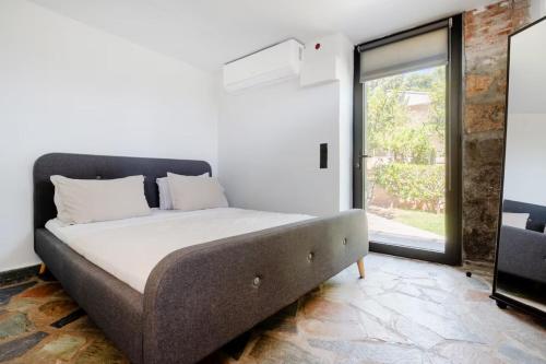 a bed in a room with a large window at Lemon Tree Villa in Chalkida