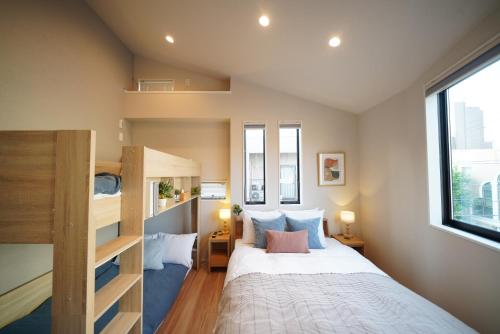 a bedroom with a bed and a bunk bed at LinksHotel 西荻窪 in Ogikubo