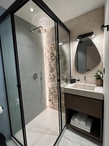 a bathroom with a shower and a sink at House 29 Suites in Heraklio
