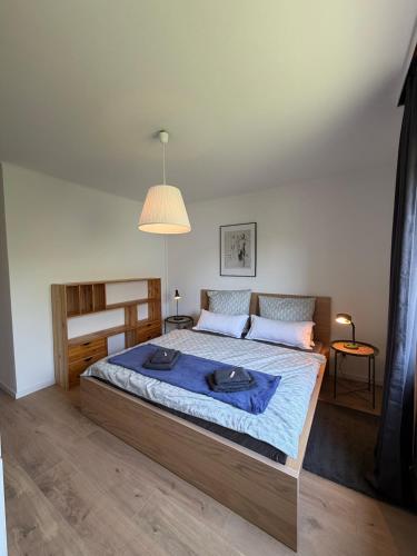 a bedroom with a large bed with a blue blanket at Schöne Aussicht in Idar-Oberstein