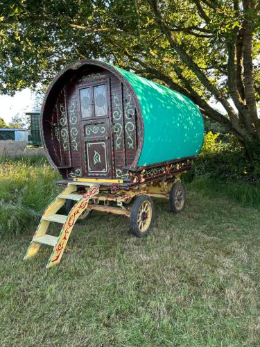a boat on a trailer on a grass field at Vardo gypsy wagon in Berwick Saint John