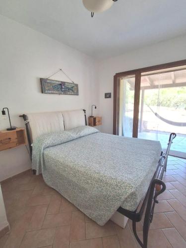 a bedroom with a bed and a sliding glass door at CASA LACONA in Lacona