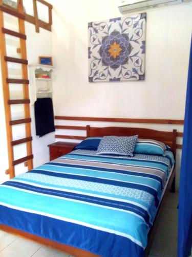 a bedroom with a bed with a ladder in it at Portón Azul in Montañita