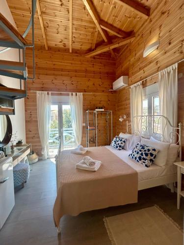 a bedroom with a large bed in a room with wooden ceilings at Sea and Sand Elafonisos in Elafonisos