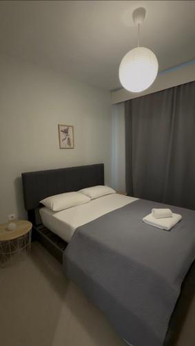 a bedroom with a large bed and a lamp at Mountain & Sea Escape in Leptokarya