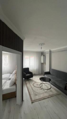 a living room with a bed and a couch at Divan Kars Suit in Kars