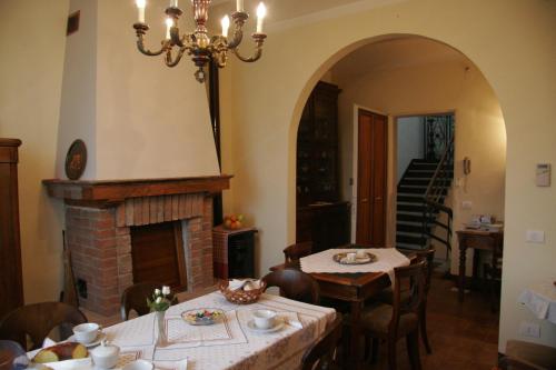 a dining room with two tables and a fireplace at Agriturismo Antica Golena in Guastalla