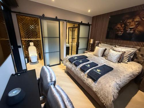 a bedroom with a bed and a chair in it at Villa B&B Bovenkarspel in Bovenkarspel