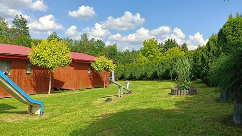 a playground with a slide in a yard at Noclegi U Renaty Solina in Solina