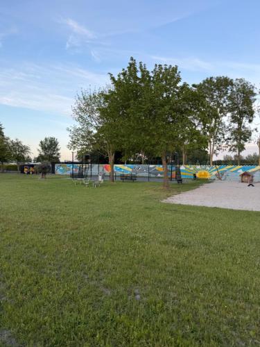 a park with a tree and a playground at Vakantiepark In Style in Dronrijp