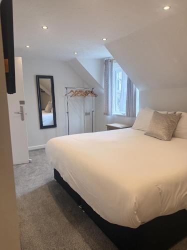 a bedroom with a large white bed and a window at Star Studios in Southampton