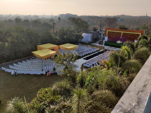 an aerial view of a wedding venue with chairs and a stage at Star resort in Bhusāwal