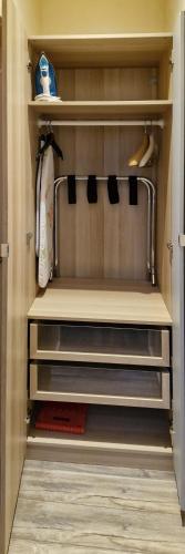 a closet with a refrigerator with shelves and a drawer at Art House in Portsmouth