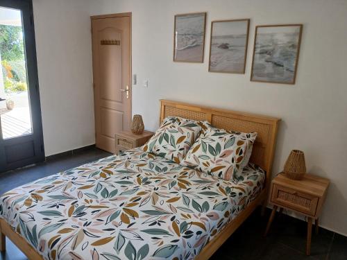 a bedroom with a bed with a colorful comforter at Chez Sab et chaton in Saint-Leu