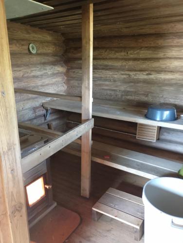 a inside view of a cabin with wooden walls at Lomamökki Rantaniemi in Töfsala
