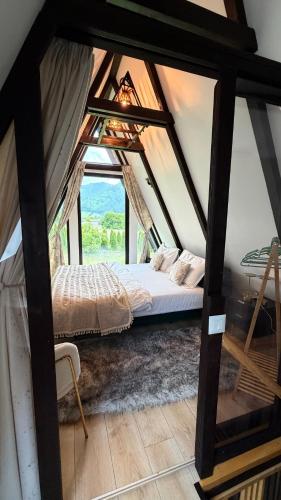 a bedroom with a bed in a room with a window at Zago Alpin in Câmpulung Moldovenesc