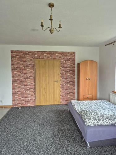 a bedroom with a bed and a brick wall at Villa Hillas in Reda
