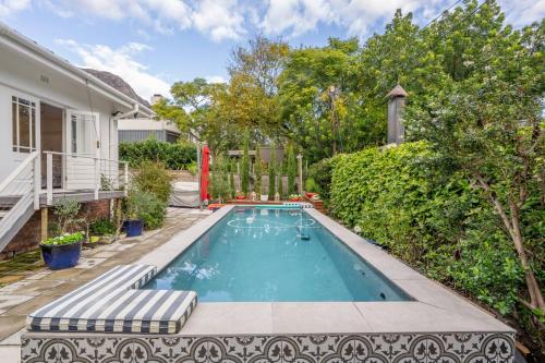 a swimming pool in the backyard of a house at 8 Sleeper, 4 Bedroom Home in Franschhoek in Franschhoek