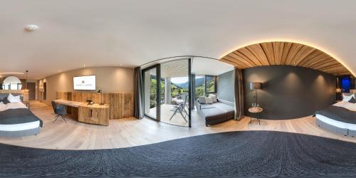 a room with two beds and a large mirror at Amonti Wellnessresort in Cadipietra