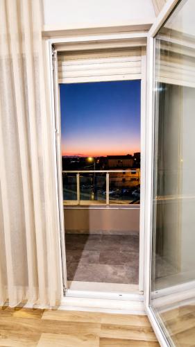 an open window with a view of a city at Hotel RADOJA in Shkodër