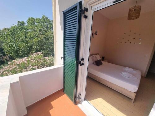 a room with a bed and a large window at Seaside Garden House 7 in Dassia
