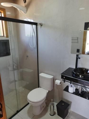 a bathroom with a toilet and a glass shower at Cabana Mais Natureza in Santo Amaro da Imperatriz