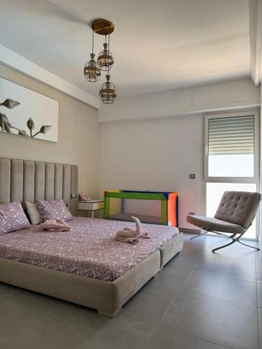 a bedroom with a large bed and a chair at Meditranee Sea View in Tangier