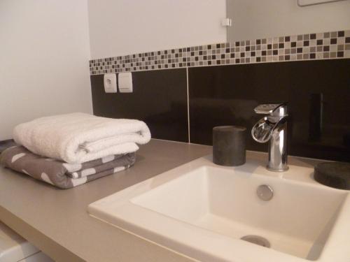 a bathroom with a sink and a towel on a counter at Le Cordeliers Presqu'ile in Lyon