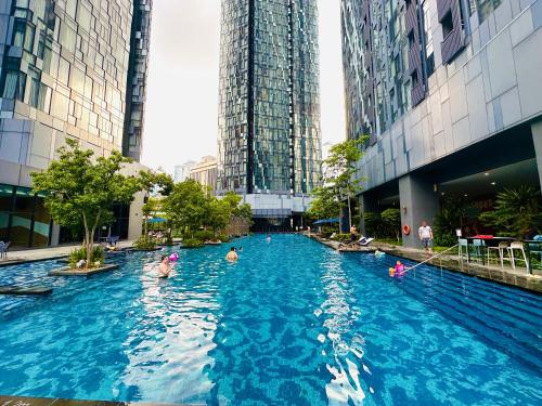 a group of people swimming in a pool in a city at GOLDEN Services Suites At Star KLCC in Kuala Lumpur