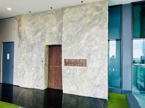 a sign on the side of a building with a door at GOLDEN Services Suites At Star KLCC in Kuala Lumpur