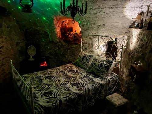a bedroom with a bed in a stone wall at THE OLD CELLAR no shower! in Locarno