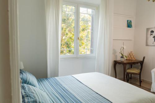 a bedroom with a bed and a window at Borghese Magnolia Suite in Rome