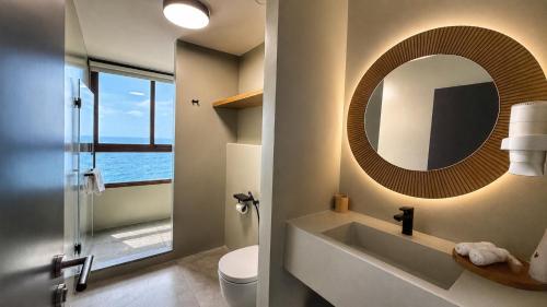 a bathroom with a sink and a mirror at Be Batroun in Batroûn