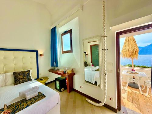a bedroom with a bed and a view of the ocean at Suite Luna in Praiano