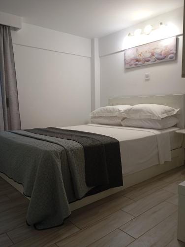a bedroom with a bed with a blanket on it at Calma Kourouta Apartments in Kourouta