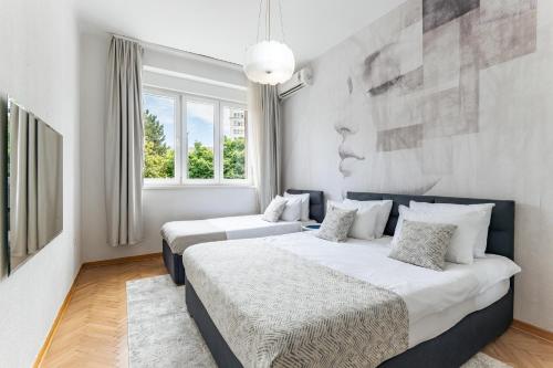 a bedroom with two beds and a painting on the wall at Belgrade CITY CENTER Apartments PARKING 12e - 7 min by walk TERAZIJE in Belgrade