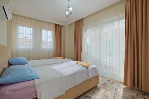 a bedroom with a bed and a large window at villa hazar in Ortaca
