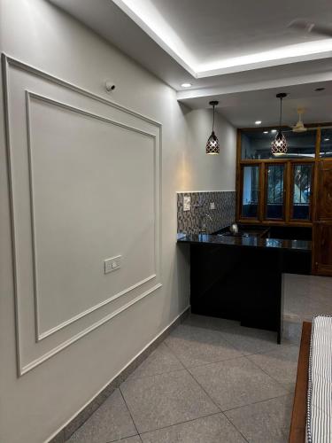 a large blank screen on the wall of a kitchen at 1Rk Karwar downtown Studio in Kārwār