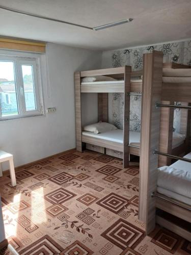 a room with two bunk beds in a room at Comfort Guest House in Borovoye