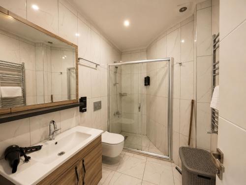 a bathroom with a shower and a sink and a toilet at NORA SUİTE in Trabzon