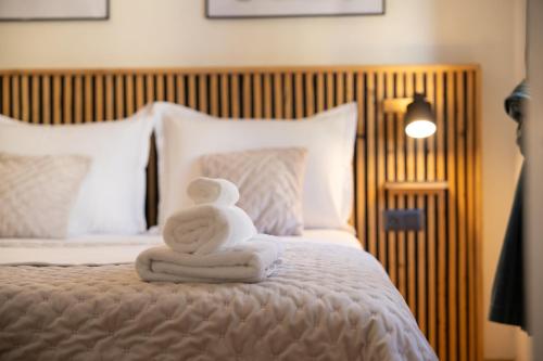 a towel animal sitting on top of a bed at Hygge Rooms Split in Split