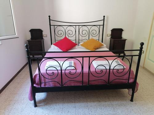 a black bed with colorful pillows on it at La Raccolta in Scheggino