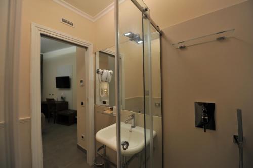 a bathroom with a sink and a glass shower at Villa Zaccardi in Rome
