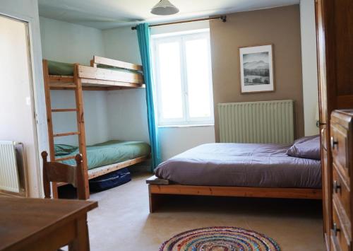 a bedroom with two bunk beds and a window at Oustal de Bourdeaux in Bourdeaux