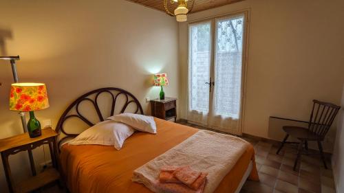 a bedroom with a bed and a window at La maison de papy près de la plage in Barbâtre